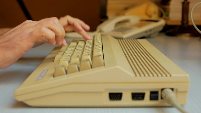 Man hand typing on old computer