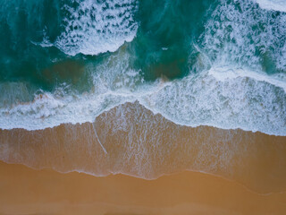 Aerial view of drone. Scene of top view beach and seawater on sandy beach in summer. Nature and travel concept.