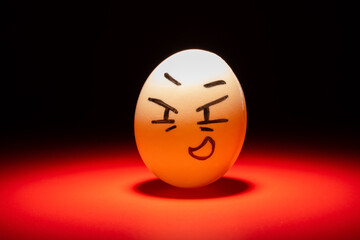 smiling egg face highlighted in dark