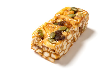 sweet caramel treats with raisins and melon seeds on white background