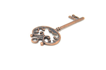 Vintage key on white background close-up. Texture, background, old, macro, wallpaper, metal, brass