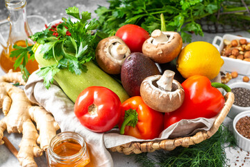  Fasting mimicking diet food. FMD to improve health and lose weight. A mix of vegetables, nuts, herbs, seeds and mushrooms on a light gray background closeup