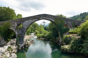 Old Roman stone bridge in Cangas de Onis on cloudy day
