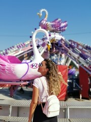 Beautiful  young woman by the  carousel  - 450373724