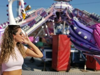 Beautiful  young woman by the  carousel  - 450374525