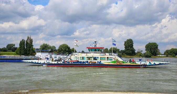 D&uuml;sseldorf (Kaiserswerth), Germany - July 9. 2021: View on river rhine with passenger, car and bike ferry