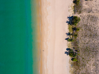 Aerial view high angle view Top-down seawater wave on sandy beach. Aerial view above beach sea in tropical beach sea.