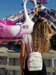 Beautiful  young woman by the  carousel  - 450376376