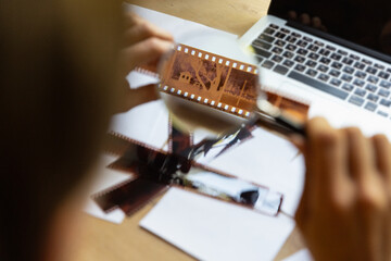 One young Caucasian man, photographer, cameraman with professional camera, equipment during working at office, indoors. Concept of occupation, job, education