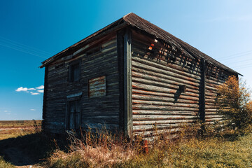 Old barn near pond. Country landscape. Green landscape background.