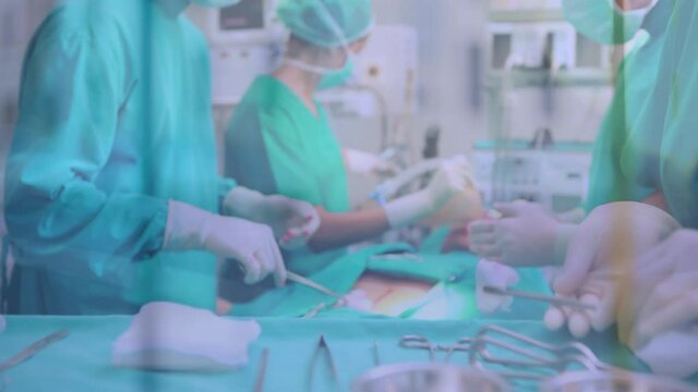 Animation of cityscape over group of doctors during surgery