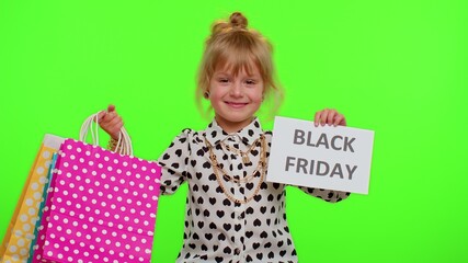 Fototapeta premium Little blonde kid child girl showing Black Friday inscription banner text, advertising discounts, smiling looking amazed with low prices, shopping on big sale day. Children on chroma key background