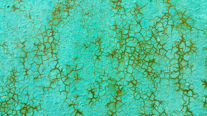 Texture of green painted metallic wall cracked and rusty