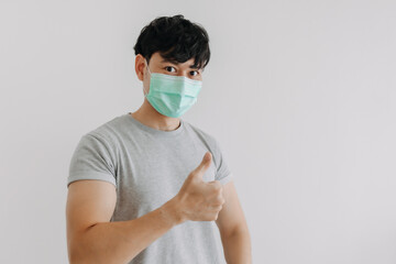 Asian man wear mask and present empty space for advertisement.