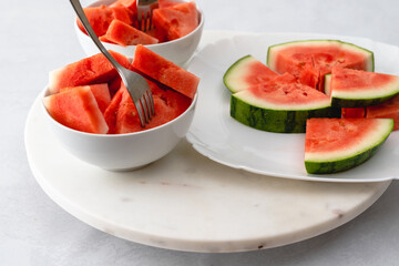Fresh watermelon slices close up in a bowl on marble board. Dessert, fruit salad - Powered by Adobe