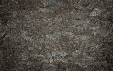 Dark chipboard panel. Recycled wood wall. Graduated filter. Background for conceptual messages.