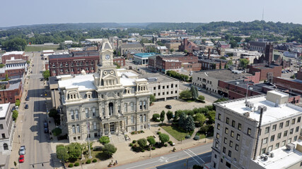 An aerial establishing shot of the Muskingum County Courthouse and clock tower in downtown...
