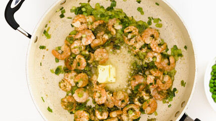 Shrimp roasted on a frying pan with butter and green onion
