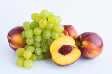Naklejka na ściany i meble Close-up on nectarine and green grapes on the white background