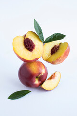Balance of nectarines on the white background.Close-up. Location vertical.
