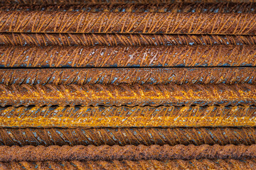 Pattern of Rusty Reinforced Steel Bars in a Stack with Contrast