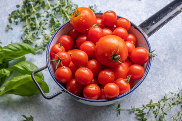 Fresh picked tomatoes from garden in bowl with herbs