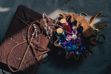 A romantic image of a dice bag, notebook, and potion bottles in the sun