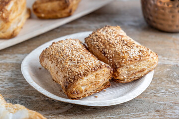 Potato Burekas on wooden background. Israeli Savory Potato Pastries. Bourekasim, Bureka, Boureka, Burekas, Borekas, Burekasim