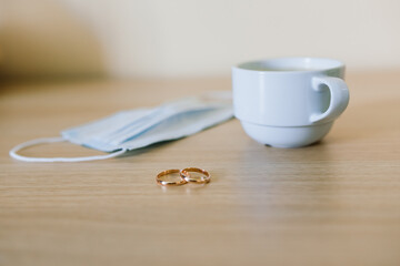 Wedding ring with medical face mask. Divorce and marriage separation during Coronavirus pandemic.