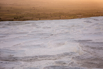 Pamukkale carbonate mineral field at sunset
