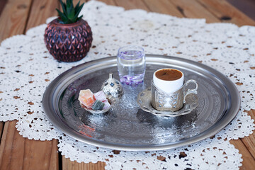 Turkish and Greek coffee on metal tray, lace cover on wooden table