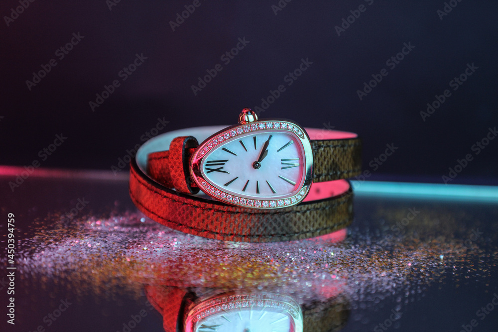 Canvas Prints Closeup shot of a hand watch with a two-layered leather strap on a reflective surface