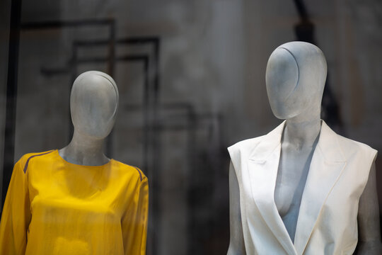 Two mannequins in a shop window. Modern mannequin for displaying clothes.