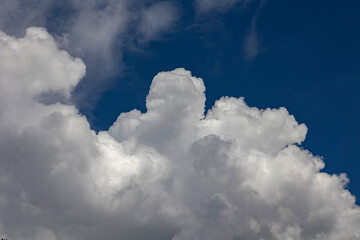 clouds Against the blue sky, Cumulus clouds are white, gray, and dark gray