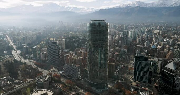 Aerial view of the city of Santiago de Chile on a snowy mountain range on a winter morning.