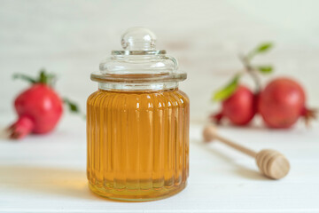 Fresh honey for Jewish holiday Rosh Hashanah on white wooden background.