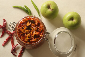 Sweet and spicy Pickled Green apple or achar made with finely sliced green apple preserved in brine, vinegar, edible oil along with indian spices