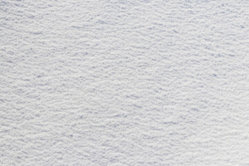 Uniform snow cover. Snow texture on a flat plot of land