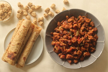 Dry roasted soya chunks with onions tomatoes and spices. Prepared with Kerala style meat masala in coconut oil. Served with indian flatbread.
