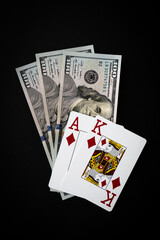 Poker cards King Ace of diamond high card with 300 Dollar bills on black background