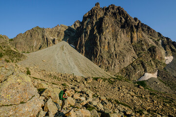 hiker on the road, Midi d'Ossau peak, 2884 meters, Pyrenees National Park, Pyrenees Atlantiques, France