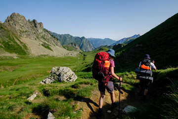 hikers descending into the valley, Col de Souzon, Midi d'Ossau peak, 2884 meters, Pyrenees National Park, Pyrenees Atlantiques, France