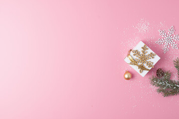Christmas decorations with gift on pink background. Flat lay, copy space