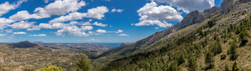 Fototapeta na wymiar panoramic view coast, mountains and a beatiful sky since bernia mountain. mediterranean coast landscape located in the Valencian Community, Alicante, Spain