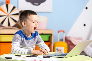 Little boy with laptop training pronounce letters at home - obrazy, fototapety, plakaty