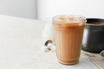 Glass of tasty iced coffee on table