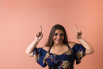 Latin white woman pointing her finger up