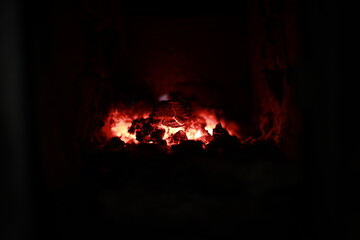 heated stove in the house with red coals and fire