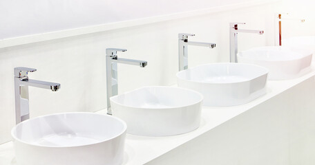 Ceramic sinks with faucets for bathrooms on exhibition
