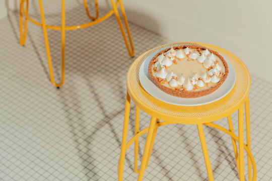 Icebox pie on a yellow stool inside of a diner